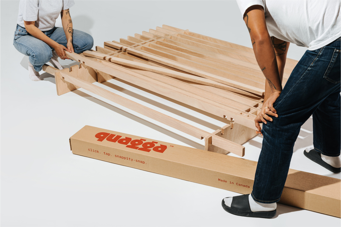 A person building the No Fuss Plus bed frame by Quagga Designs.