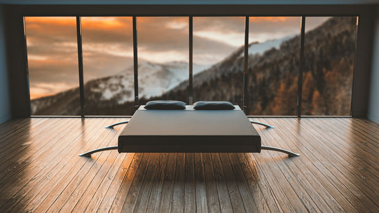 Modern bed frame in empty bedroom with big windows