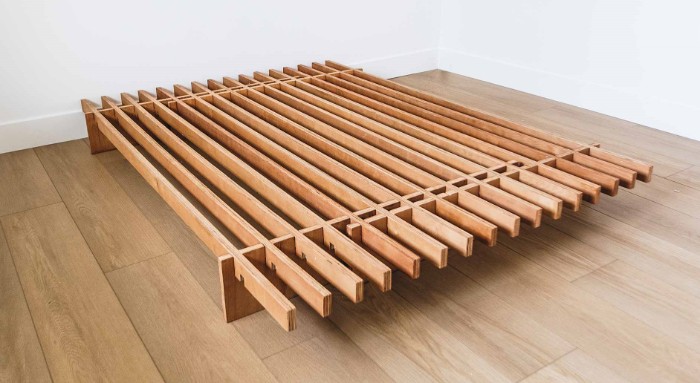 The Quagga No Fuss Plus bed frame on a wooden floor with white walls